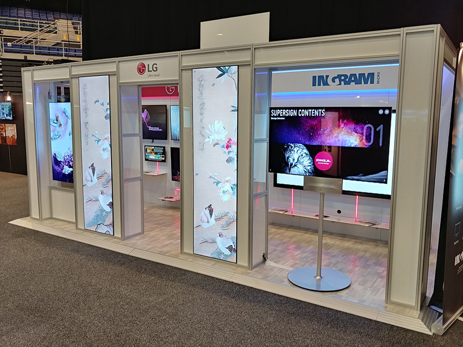 Exhibition stand in a white aluminium frame with tall backlit panels of bird and flower artwork and a screen on a floor stand