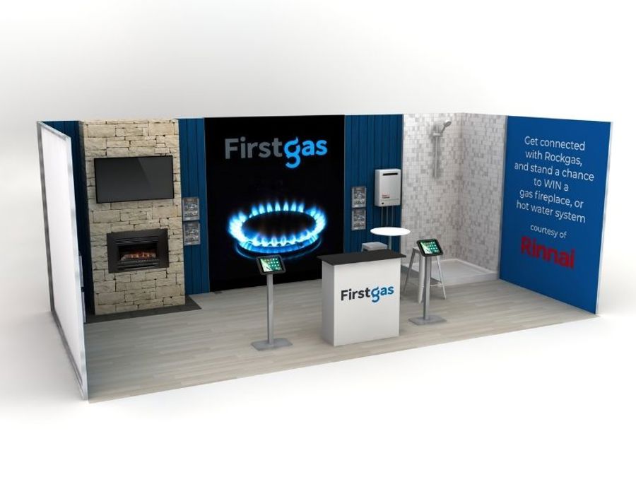 3D render of a three-sided exhibition stand design with a stone feature wall, built-in fireplace and screen, a logo wall with a gas flame graphic, a bathroom display, a branded counter and two tablet stands