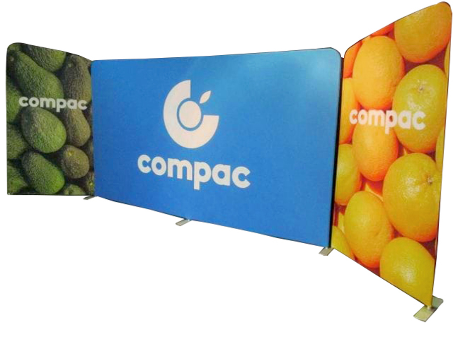 Three fabric display walls on feet: a blue centre wall with a logo, flanked by angled side walls printed with avocados and oranges