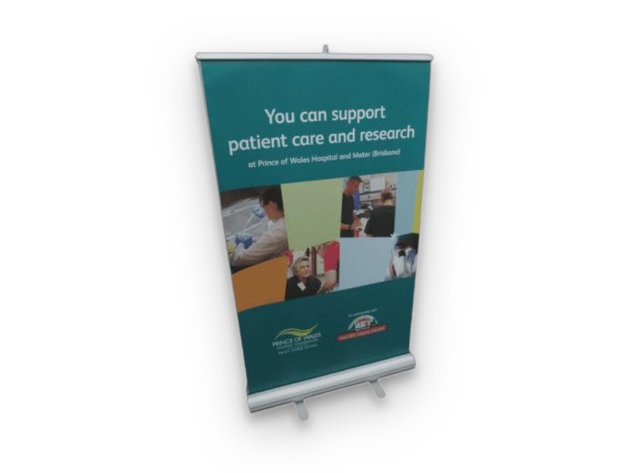 Pull-up banner stand printed with a teal fundraising message and a grid of hospital photos
