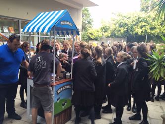 Ben & Jerry's branded sampling cart set up outside a school building